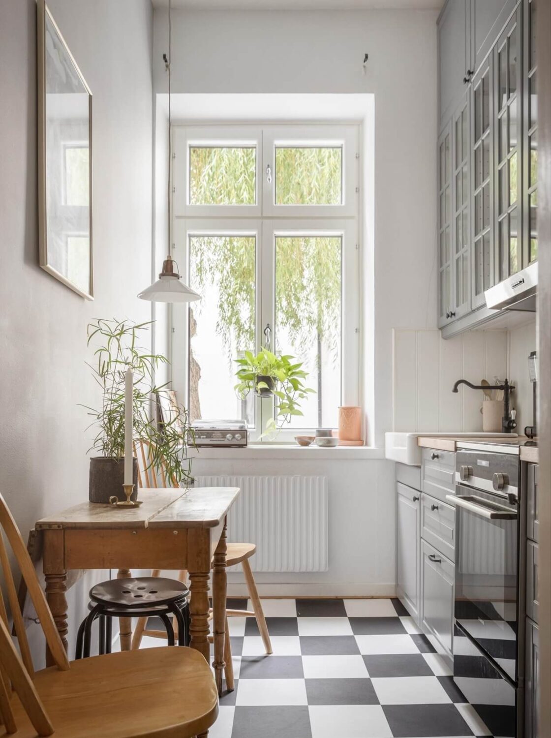 A Studio Apartment with Vintage Decor 9 kitchen-gray-cabinets-small-wooden-table-nordroom