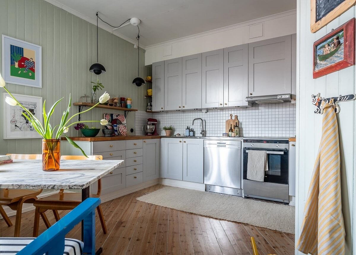 Primary Color Accents in a Light Swedish Apartment 18 kitchen-light-green-walls-wooden-floor-nordroom
