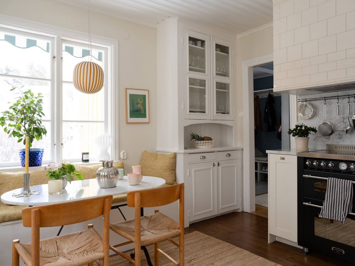 A Light Family Home in a Historic Yellow Villa 15 kitchen with breakfast table and bench seating nordroom