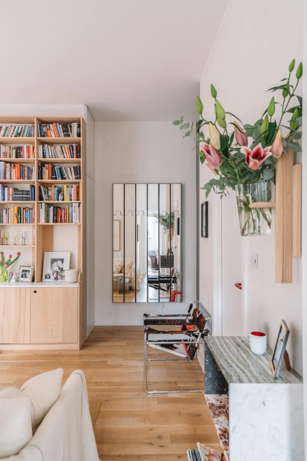 High Ceilings and Modern Design in a Light London Apartment 6 light living room wooden bookcases