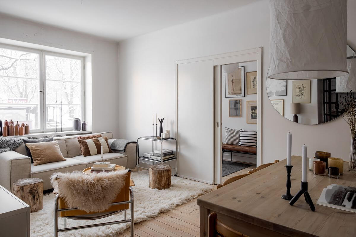 A Light Apartment with a Stainless Steel Kitchen 8 light scandinavian liivng room with dining table