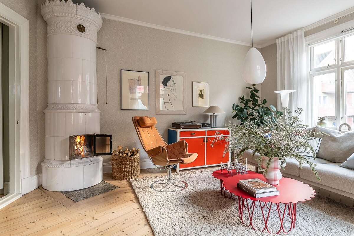 Primary Color Accents in a Light Swedish Apartment 2 living-room-round-fireplace-red-coffee-table-nordroom