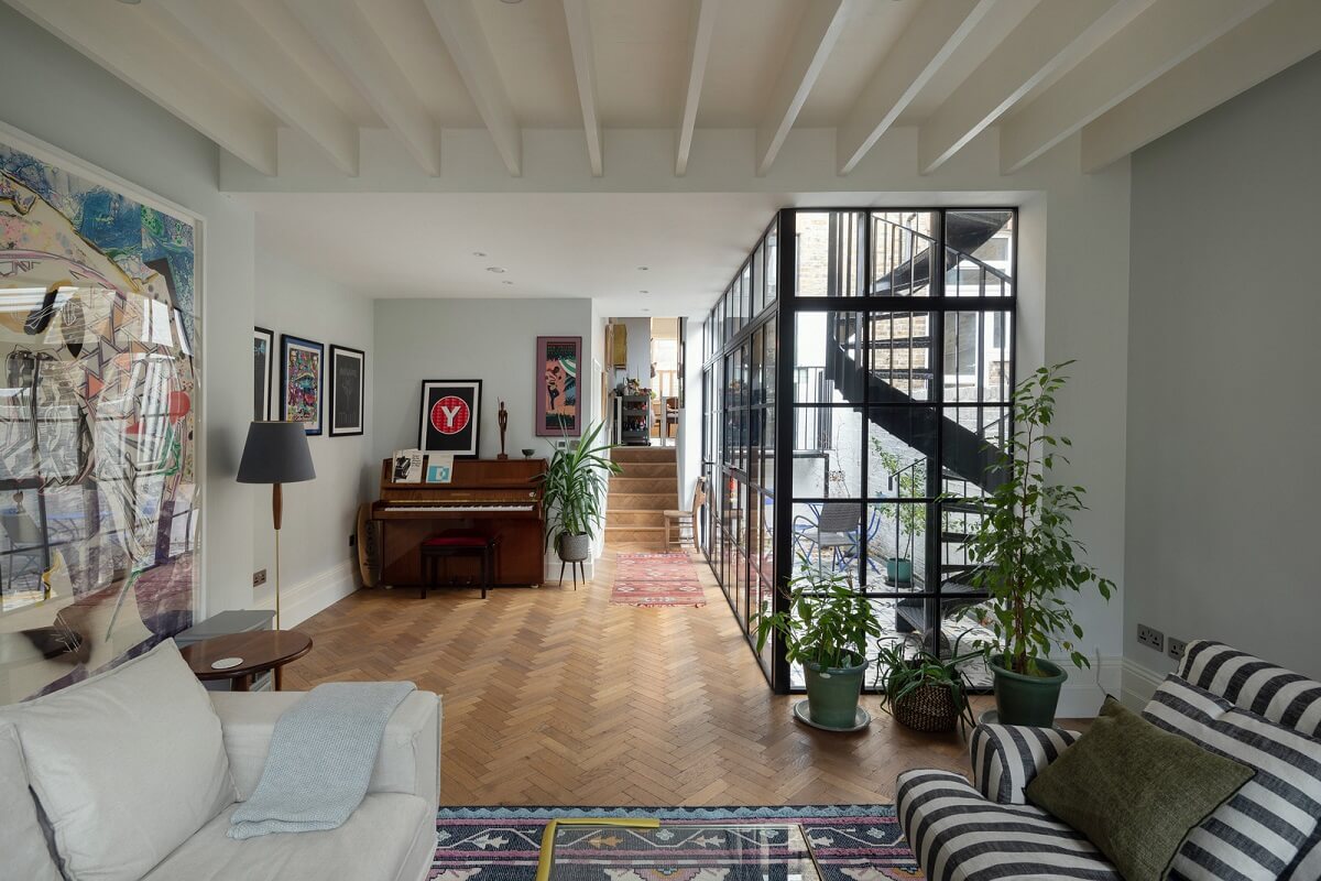 A Victorian House in London with Three Outdoor Spaces 8 living room with striped sofa industrial style windows