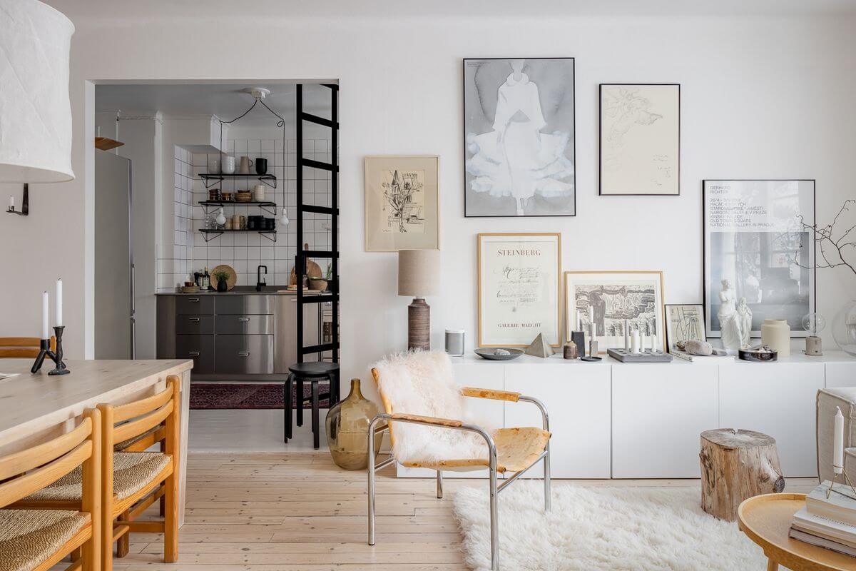 A Light Apartment with a Stainless Steel Kitchen 4 low white cabinet gallery wall living room