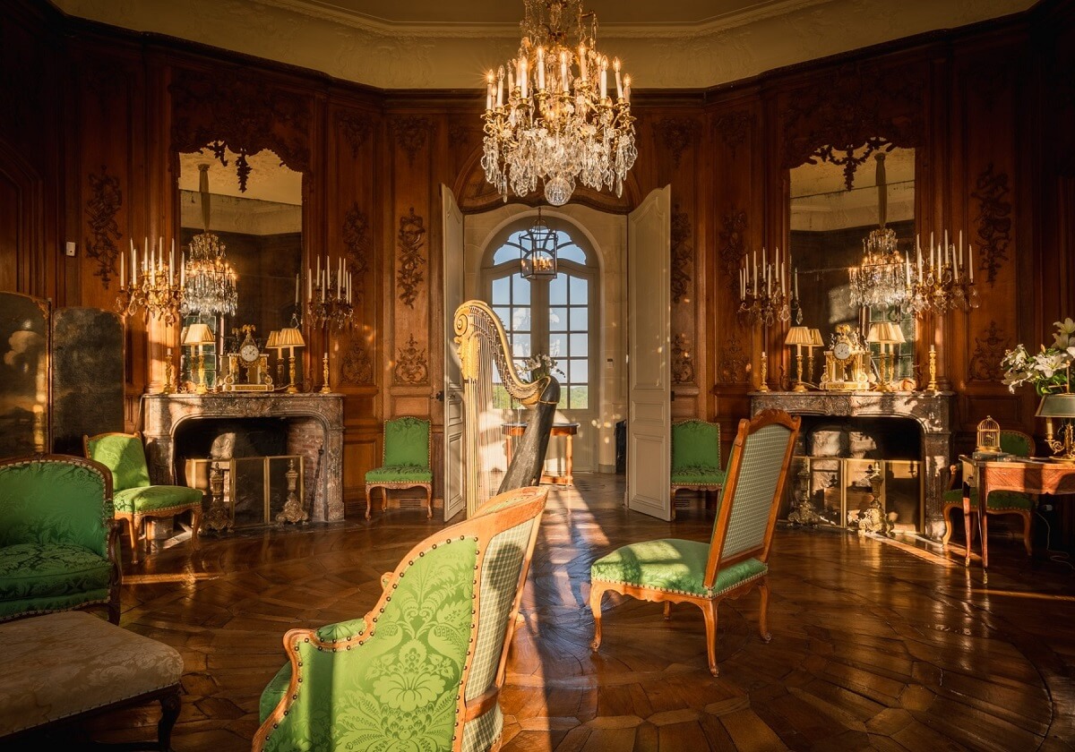 A Renovated 18th Century Chateau in France 3 music room wooden walls sunlight