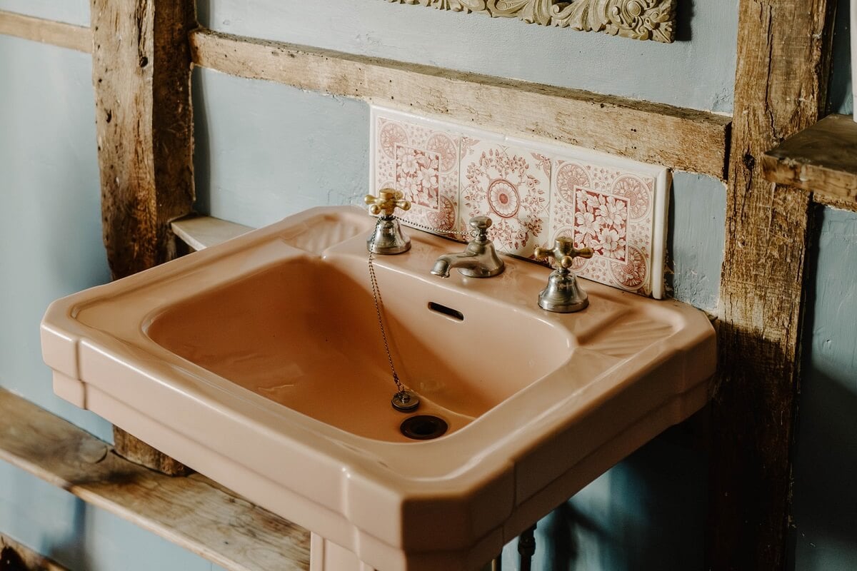 A Cozy Historic English Country House with Exposed Beams 20 pink bathroom sink