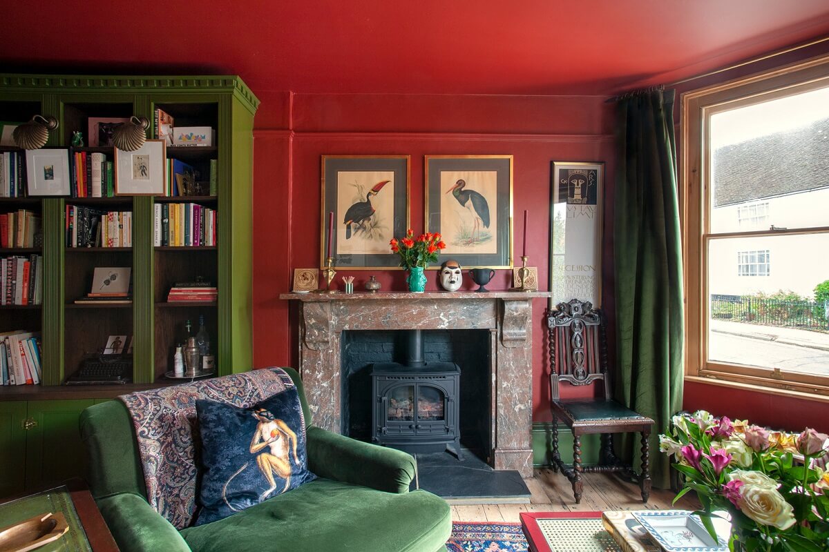 Bold Colors in a Charming Historic House in England 4 red-living-room-fireplace-green-bookcases-nordroom