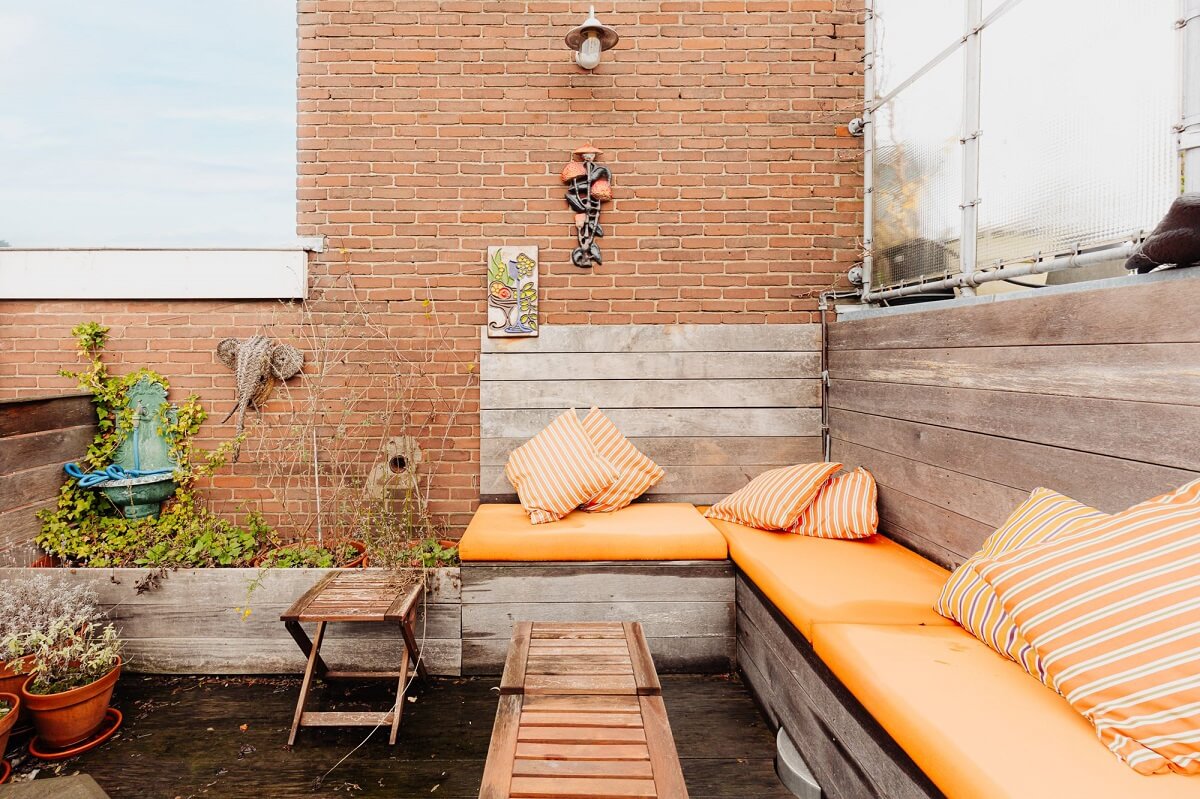 An Industrial Loft Apartment in Amsterdam 19 roof-terrace-built-in-seating-yellow-cushions-nordroom