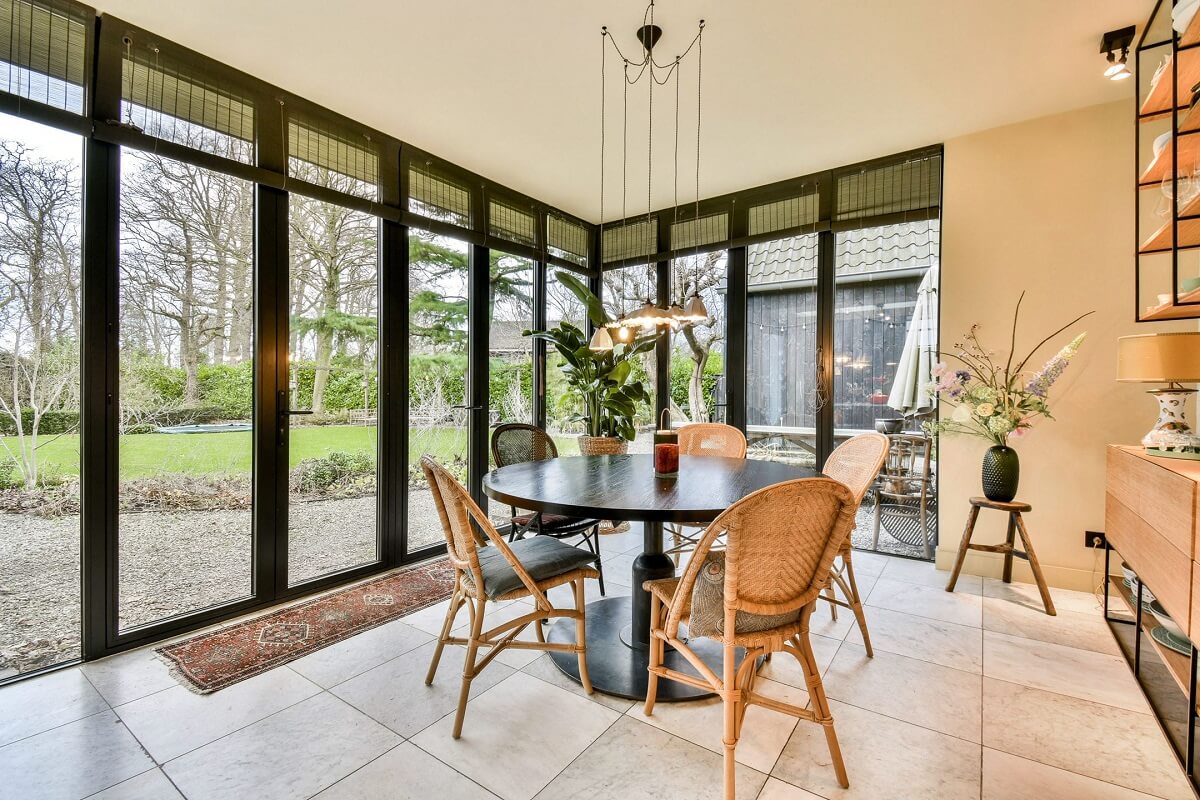 Wooden Interiors in a Historic Dutch Family Home 7 round-dining-table-floor-to-ceiling-windows-nordroom