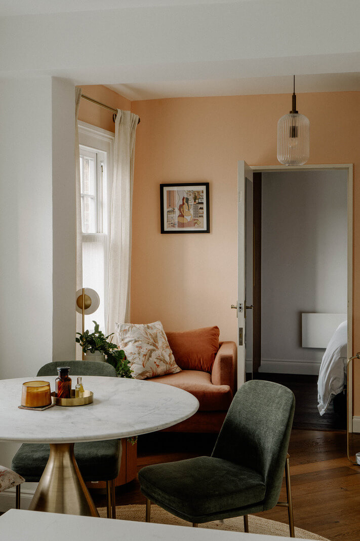 A Tiny London Apartment with Refined Materials and Colors 11 round dining table green chairs in small living room