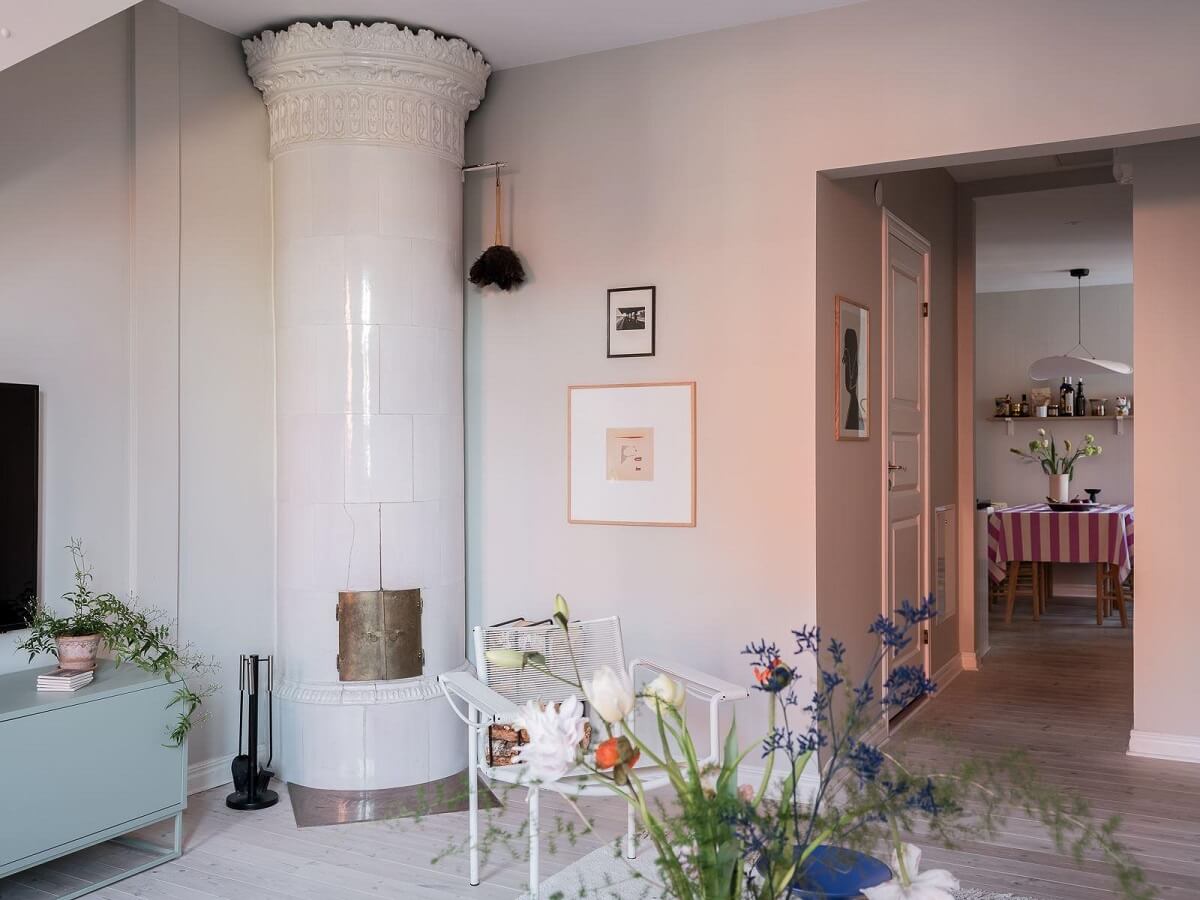 A Light-Filled Swedish Duplex is a Lovely Family Home 7 round white fireplace light scandinavian living room