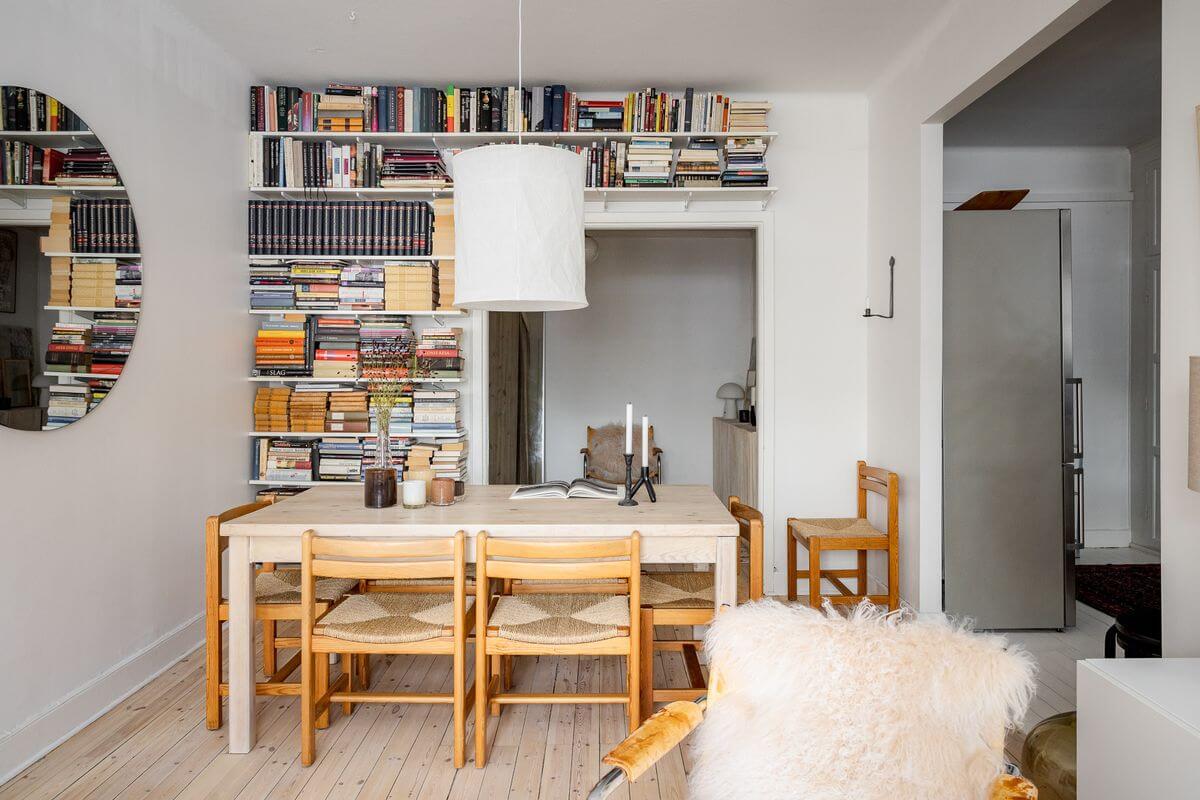 A Light Apartment with a Stainless Steel Kitchen 6 scandinavian living room wooden dining table bookshelves
