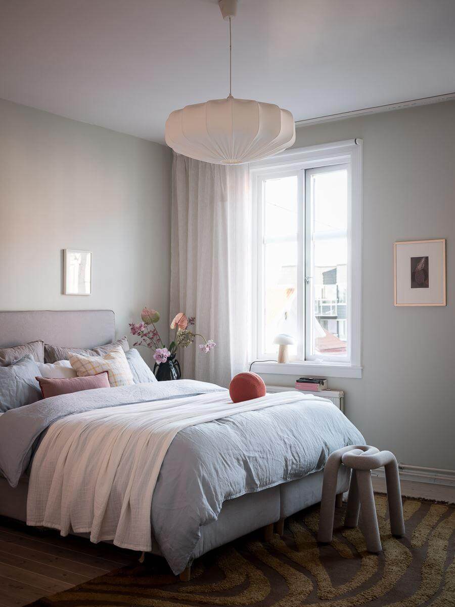 A Light-Filled Swedish Duplex is a Lovely Family Home 15 serene bedroom light gray walls rug nordroom