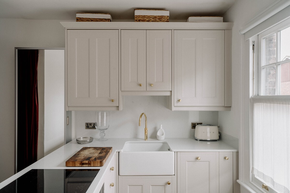 A Tiny London Apartment with Refined Materials and Colors 9 small light kitchen butler sink