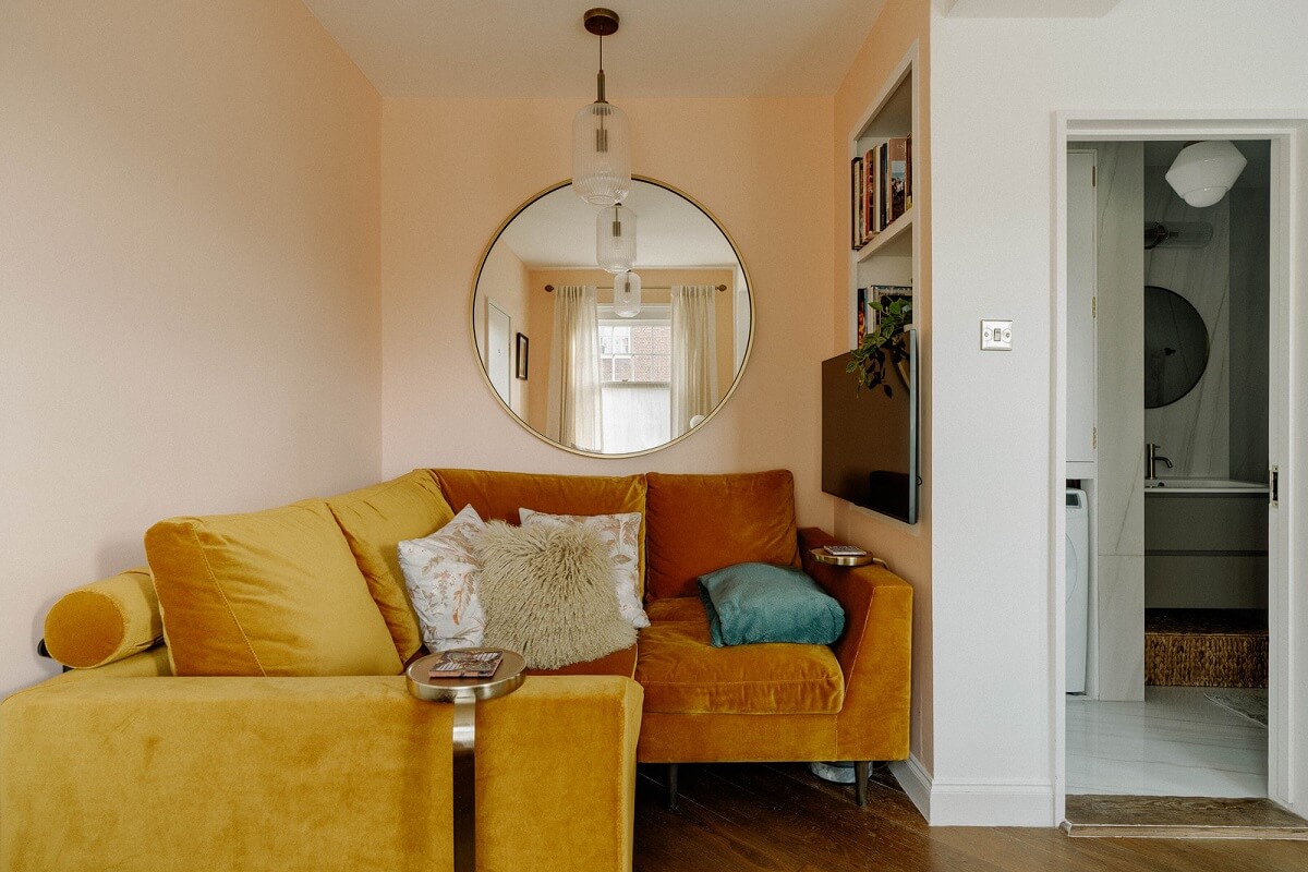 A Tiny London Apartment with Refined Materials and Colors 3 small living room pink wall ochre yellow sofa nordroom