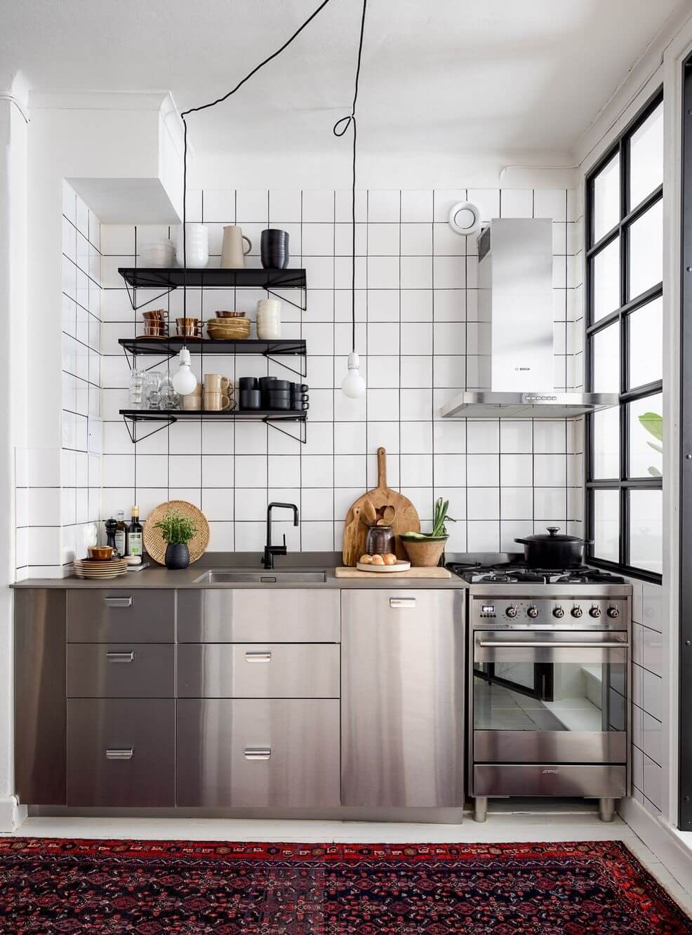 A Light Apartment with a Stainless Steel Kitchen 12 stainless steel kitchen white tiles nordroom