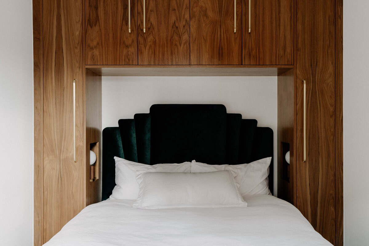 A Tiny London Apartment with Refined Materials and Colors 13 tiny bedroom walnut cabinets green velvet headboard