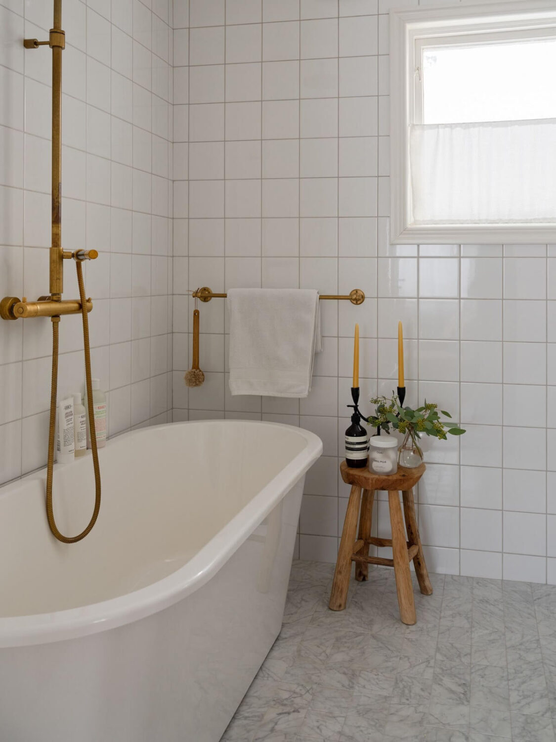 A Light Family Home in a Historic Yellow Villa 29 white bathroom brass fittings freestanding bath