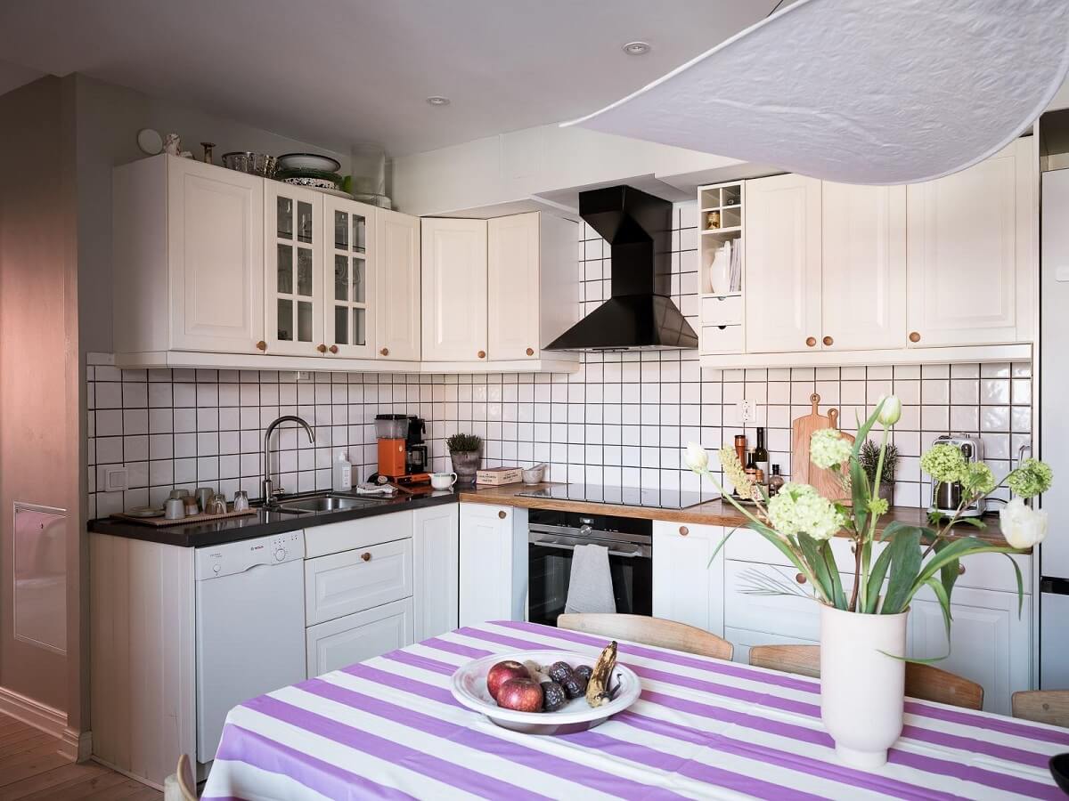 A Light-Filled Swedish Duplex is a Lovely Family Home 10 white kitchen striped table cloth nordroom