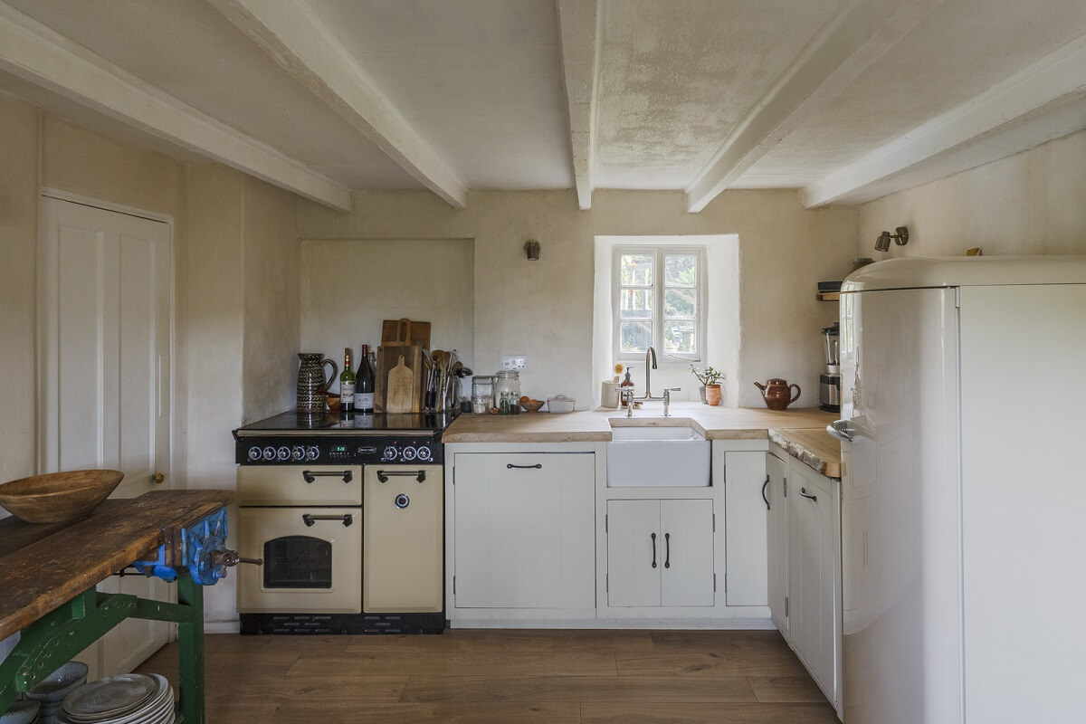 A Serene English Cottage in Cornwall 7 white-kitchen-wooden-ceiling