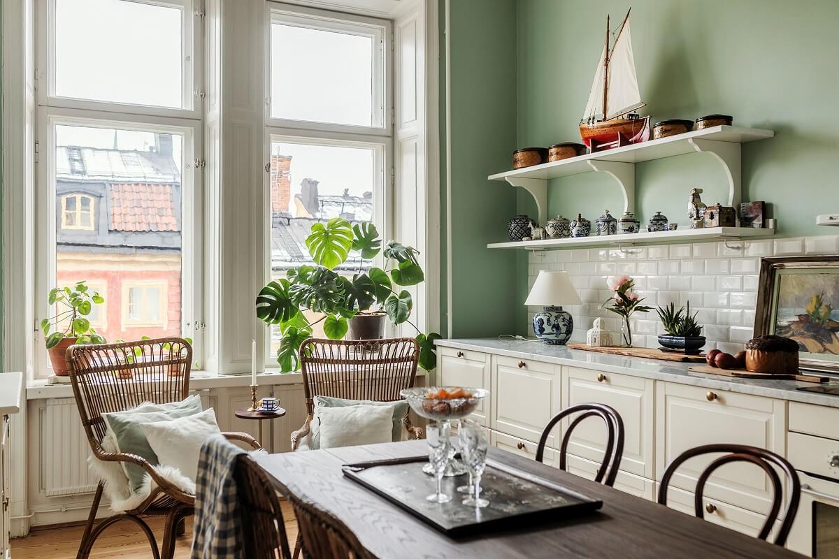 Stunning Fireplaces in a Historic Stockholm Apartment 10 wooden-dining-table-kitchen-shelves-mint-green-walls-nordroom