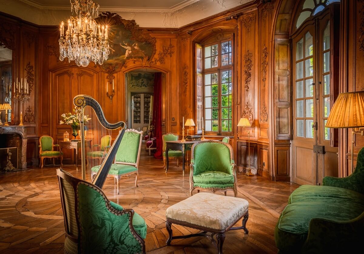 A Renovated 18th Century Chateau in France 4 wooden music room with green seating