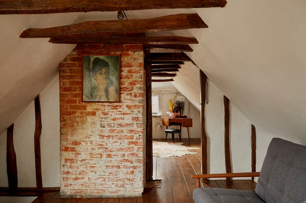 A Cozy Home with Exposed Beams in a Former Post Office 15 attic-room-exposed-beams-brick-wall