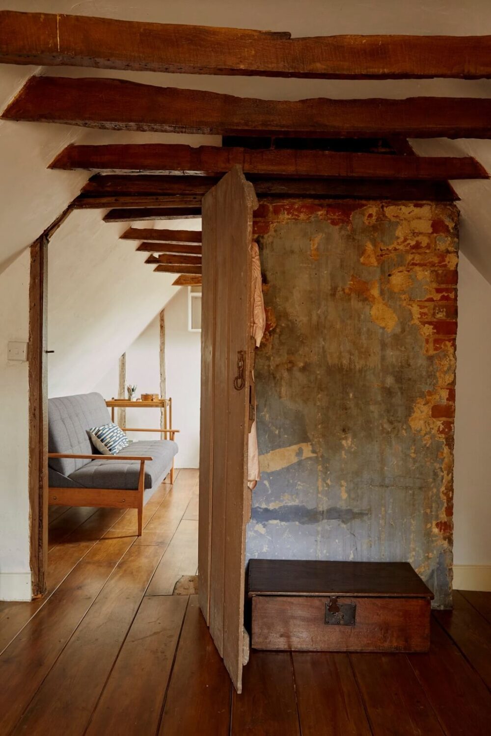 A Cozy Home with Exposed Beams in a Former Post Office 16 attic-room-wooden-floorboards