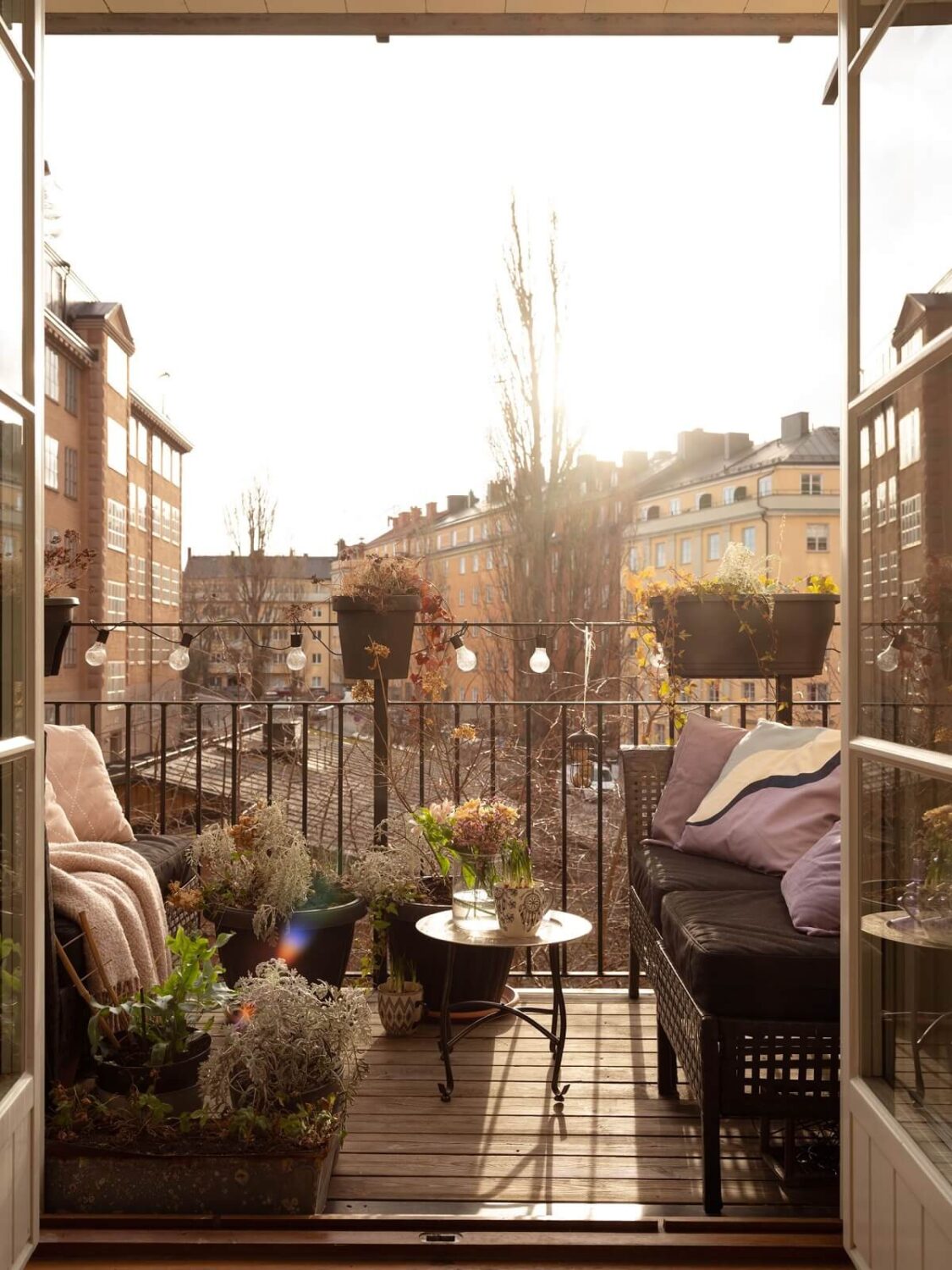 A Swedish Apartment with Light-Filled Rooms 18 balcony overlooking stockholm buildings