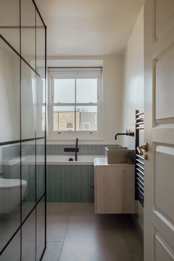 An Exposed Brick Wall in a London Duplex Apartment 16 bathroom green tiles and walk in shower