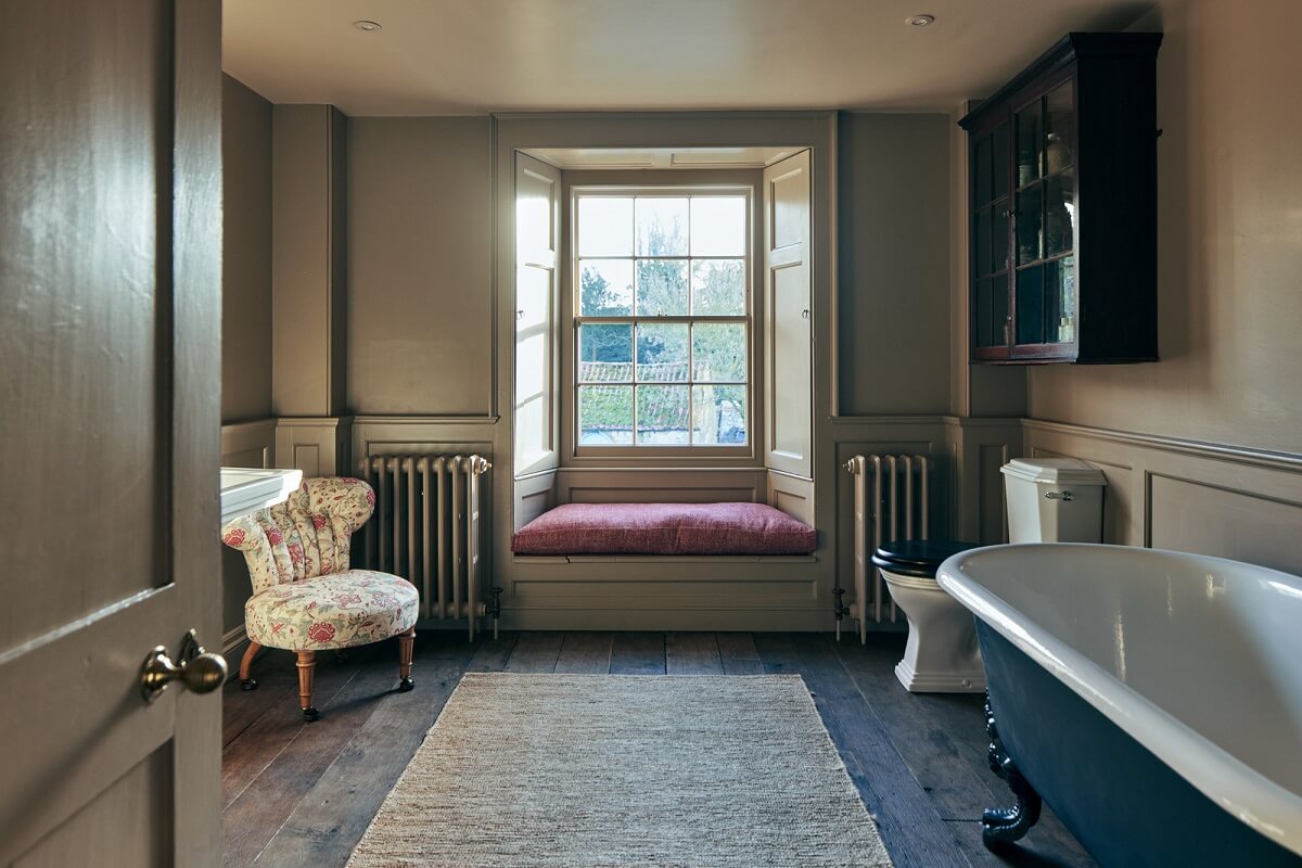 A Historic English Country House with Restored Interiors 26 bathroom with clawfoot bath and window seat