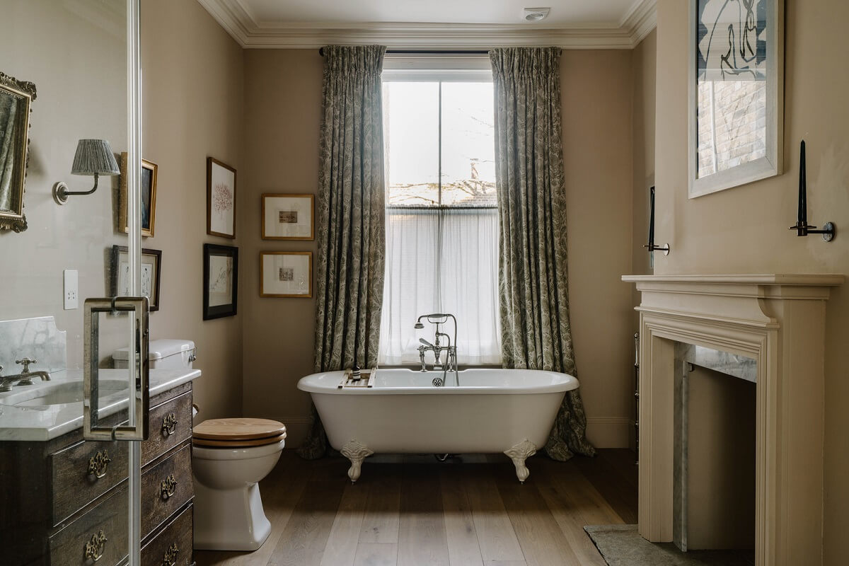 A Restored and Extended London Townhouse 18 bathroom with freestanding bath and fireplace