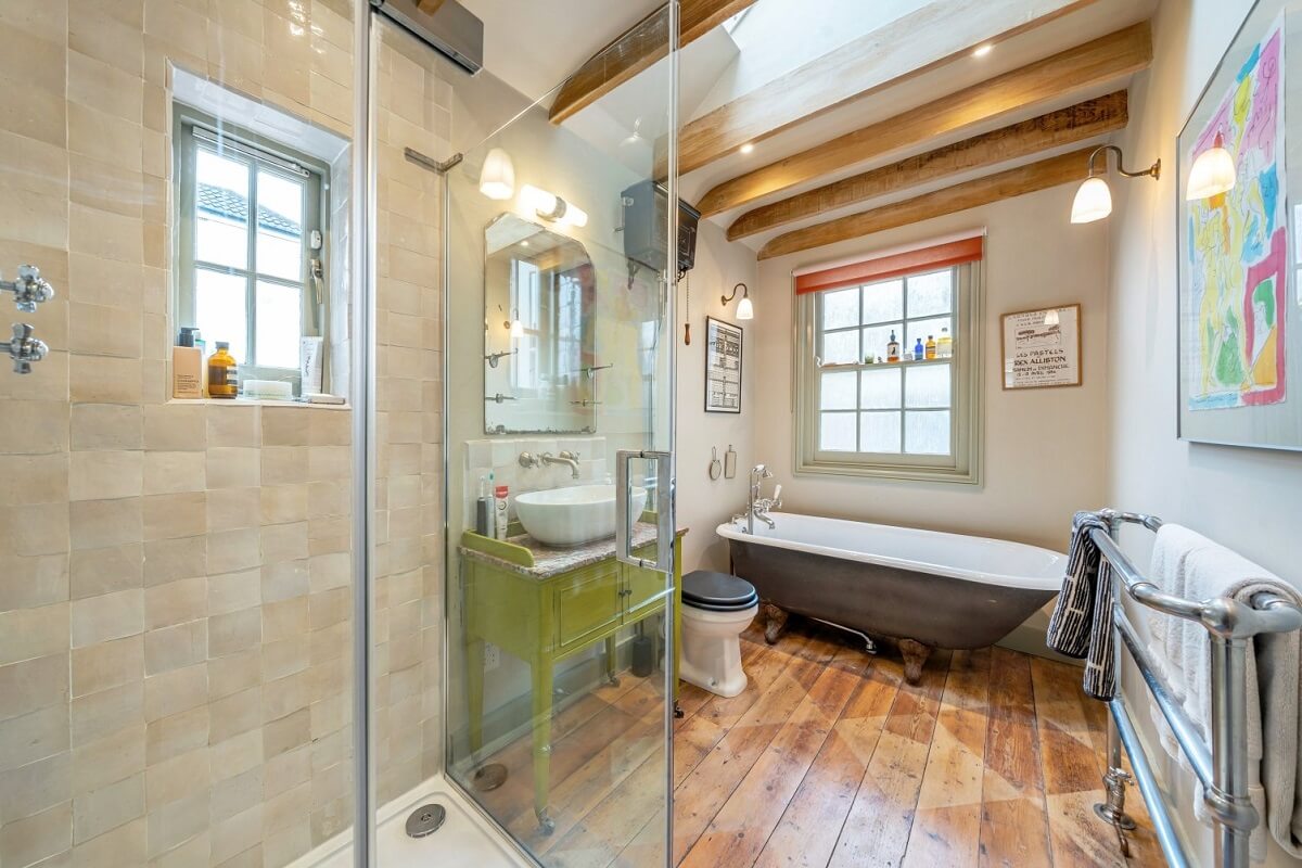 A Colorful Historic Family Home in London 22 bathroom with freestanding bath and wooden beams nordroom
