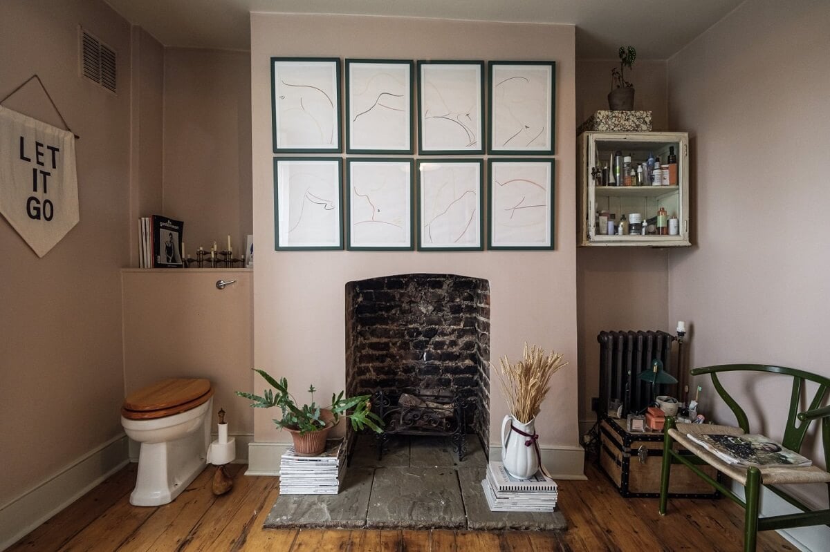 A Cozy and Charming Georgian Townhouse in London 27 bathroom with soft pink walls fireplace and wooden floorbaords