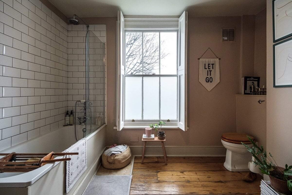 A Cozy and Charming Georgian Townhouse in London 25 bathroom with wooden floorboards and pink walls nordroom