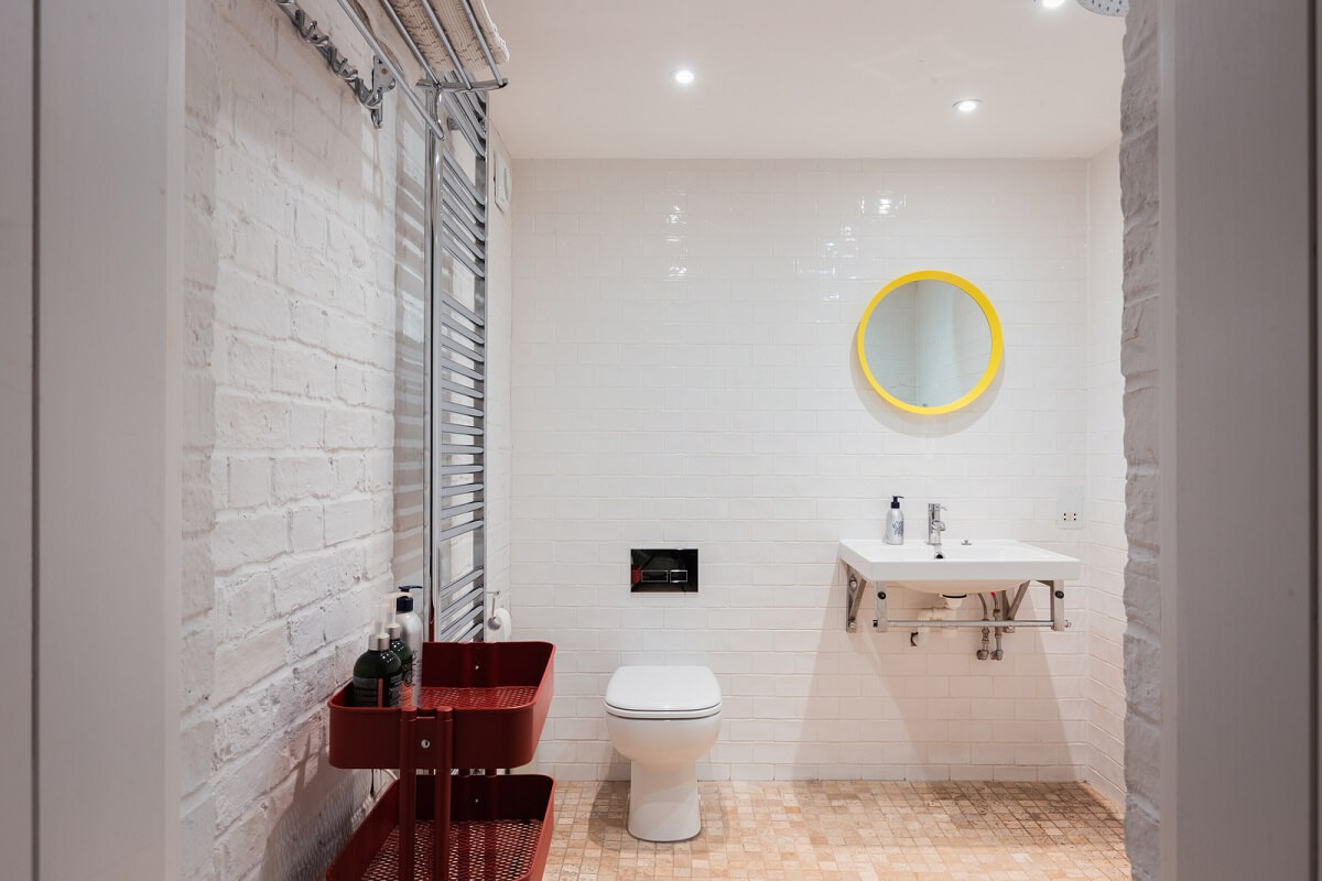A Home with Cottage Interiors in a Former Cambridge Shop 22 bathroom yellow mirror