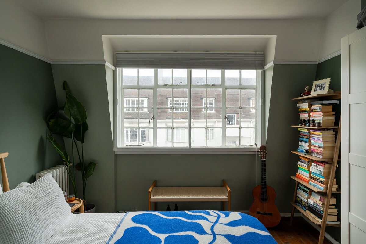 A Charming Top-Floor Apartment in an Art Deco Building 10 bedroom with green walls and wooden floor