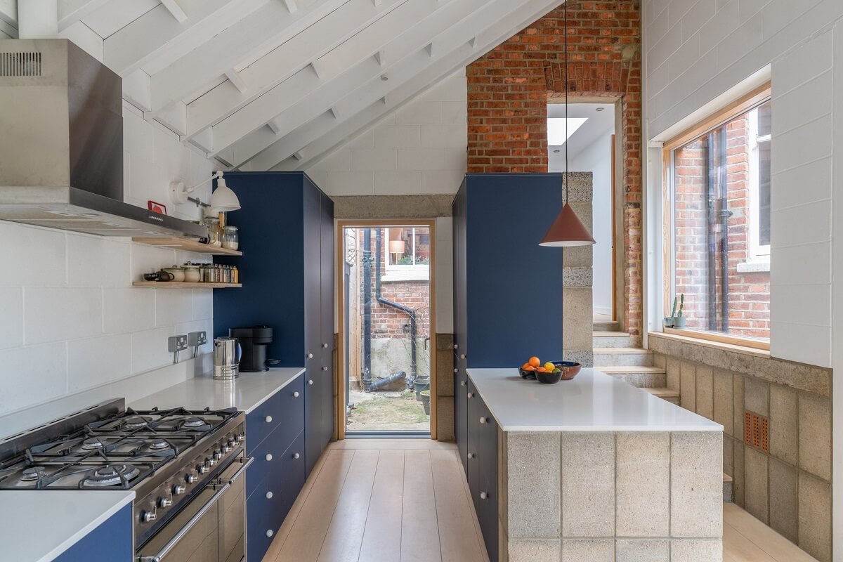 An Award-Winning Apartment with a Modern Extension 19 blue kitchen cabinets and exposed brick wall nordroom