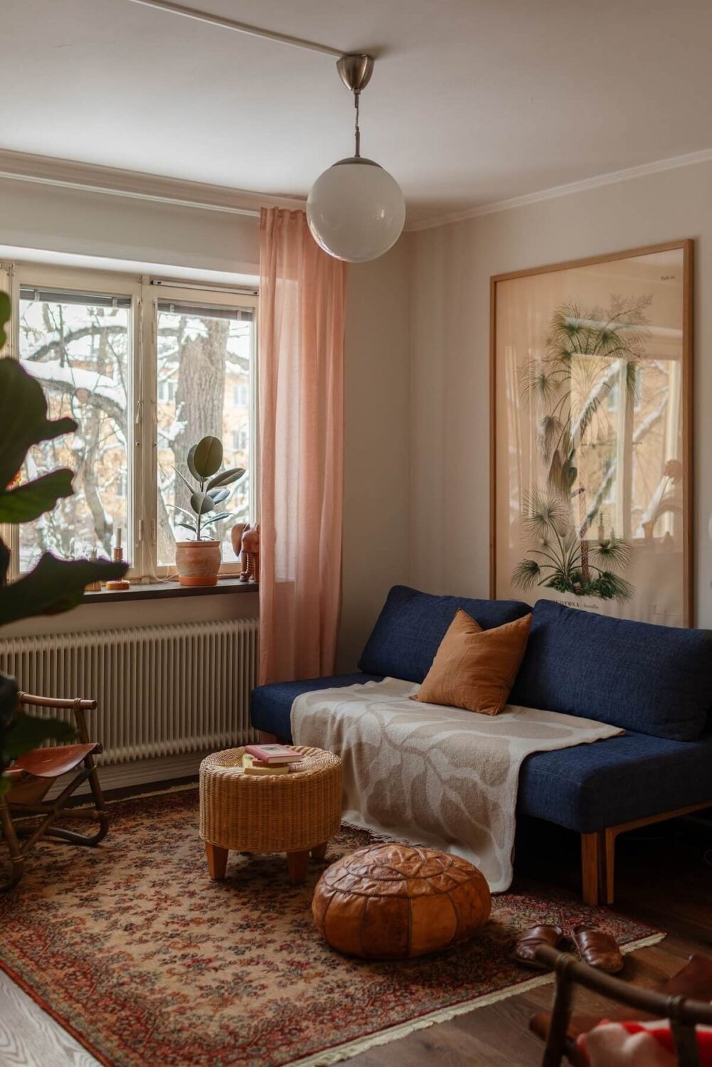A Small Swedish Apartment with Warm Color Accents 2 blue sofa in small living room with warm color accents nordroom