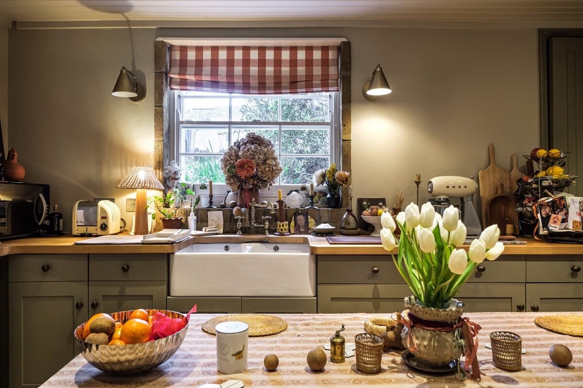 A Cozy and Charming Georgian Townhouse in London 9 cozy kitchen with butler sink and striped curtain