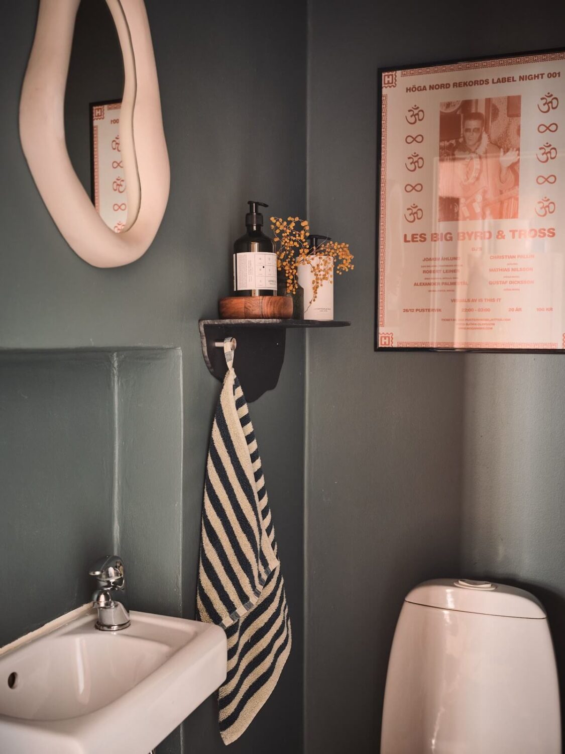 Serene Light Painted Spaces in a Swedish Apartment 17 dark-gray-walls-small-shelf-powder-room-nordroom