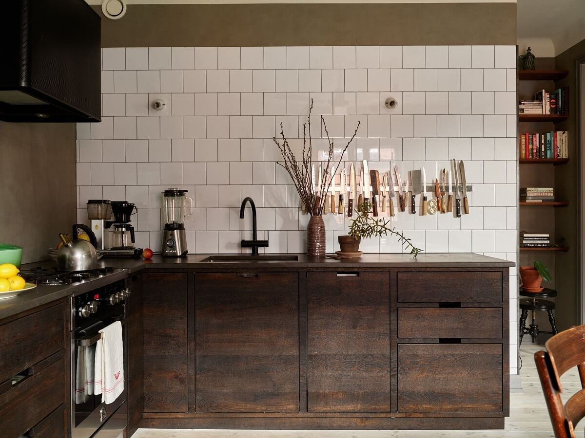 Cozy Vintage Style in a Swedish 1920s Apartment 14 dark oak kitchen cabinets with white tiles nordroom