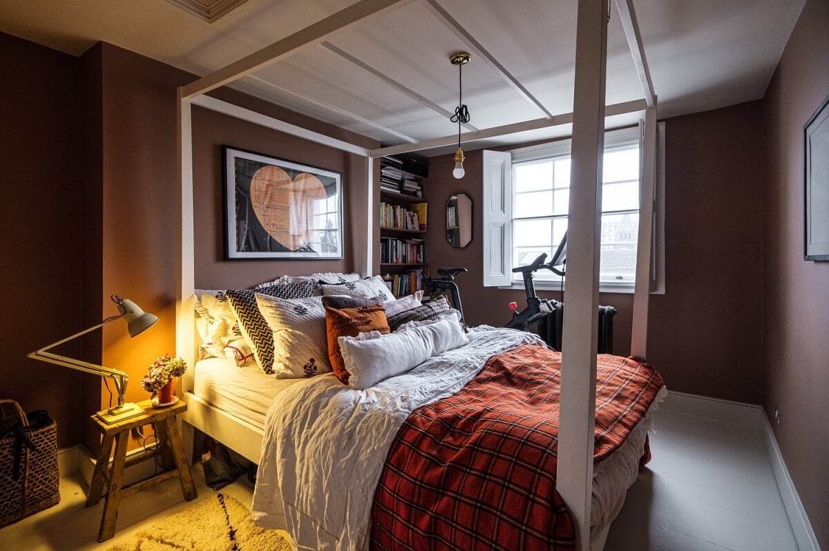 A Cozy and Charming Georgian Townhouse in London 19 dark pink bedroom with canopy bed