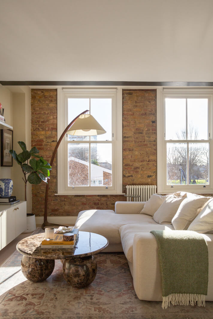 An Exposed Brick Wall in a London Duplex Apartment 2 exposed brick accent wall living room
