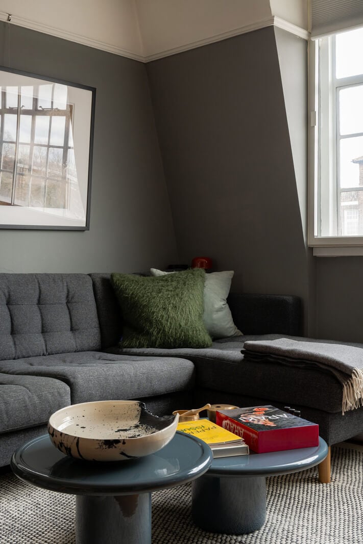 A Charming Top-Floor Apartment in an Art Deco Building 5 gray living room with slanted ceiling and wooden floor