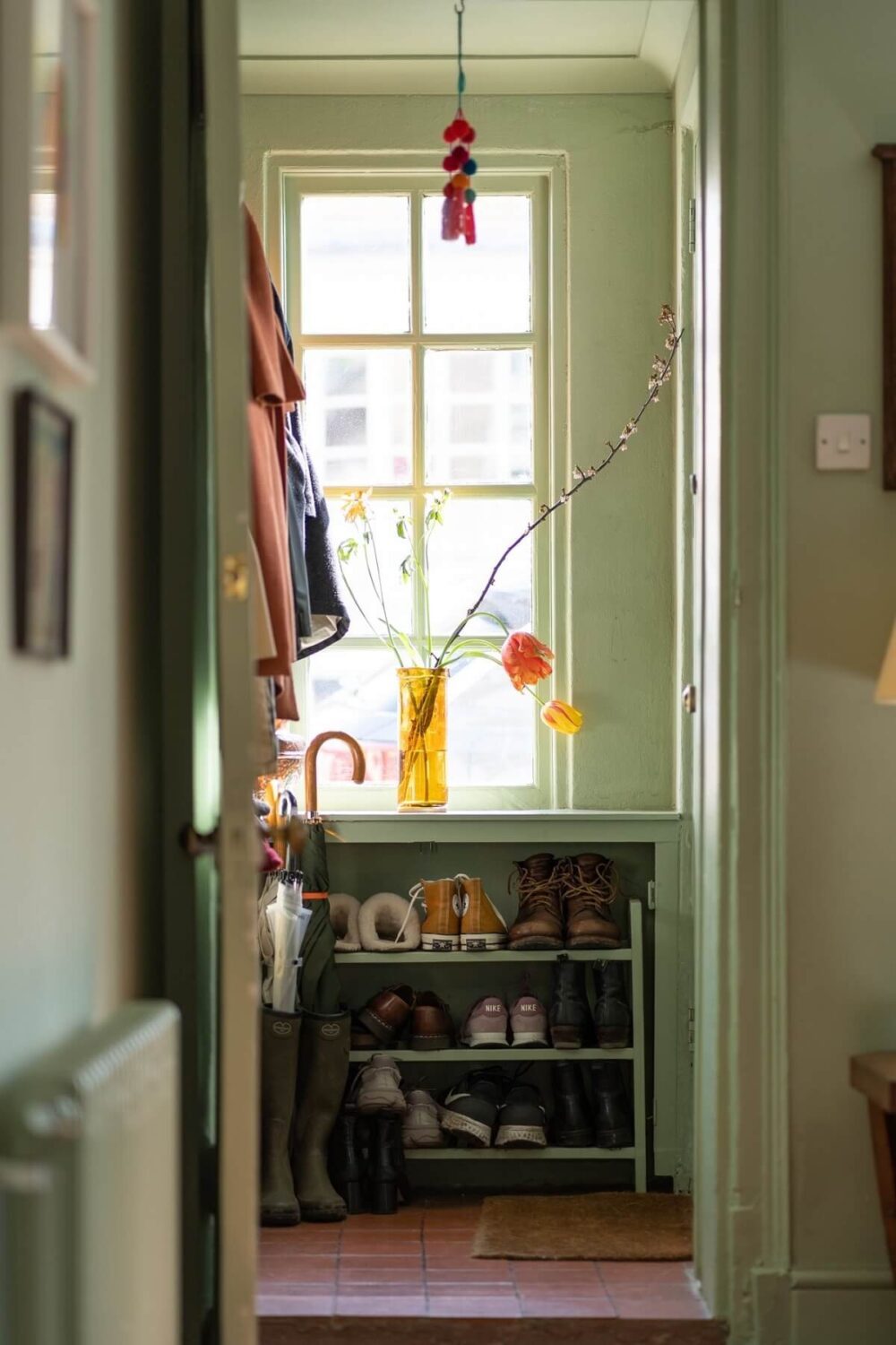 A Colorful Historic Family Home in London 3 green hallway with shoe storage