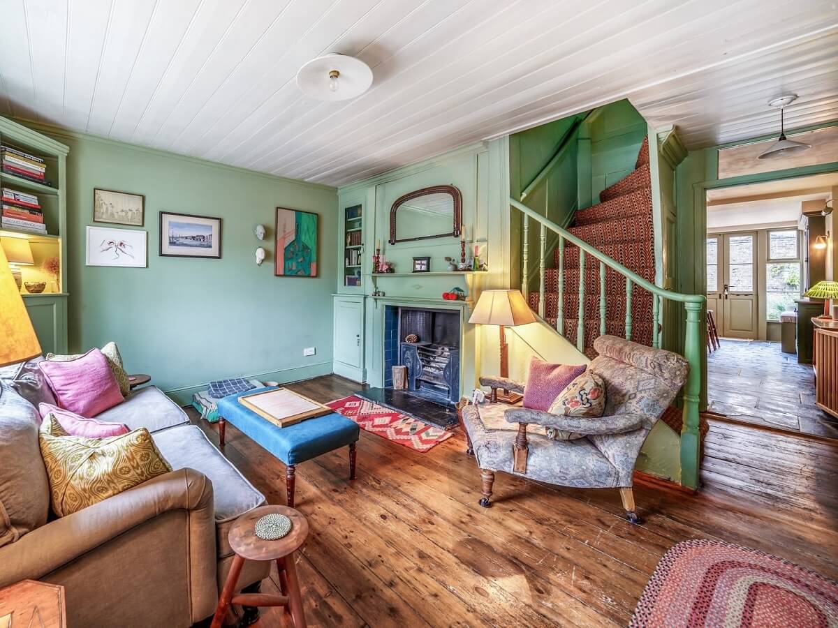 A Colorful Historic Family Home in London 1 green open plan living room with wooden floor