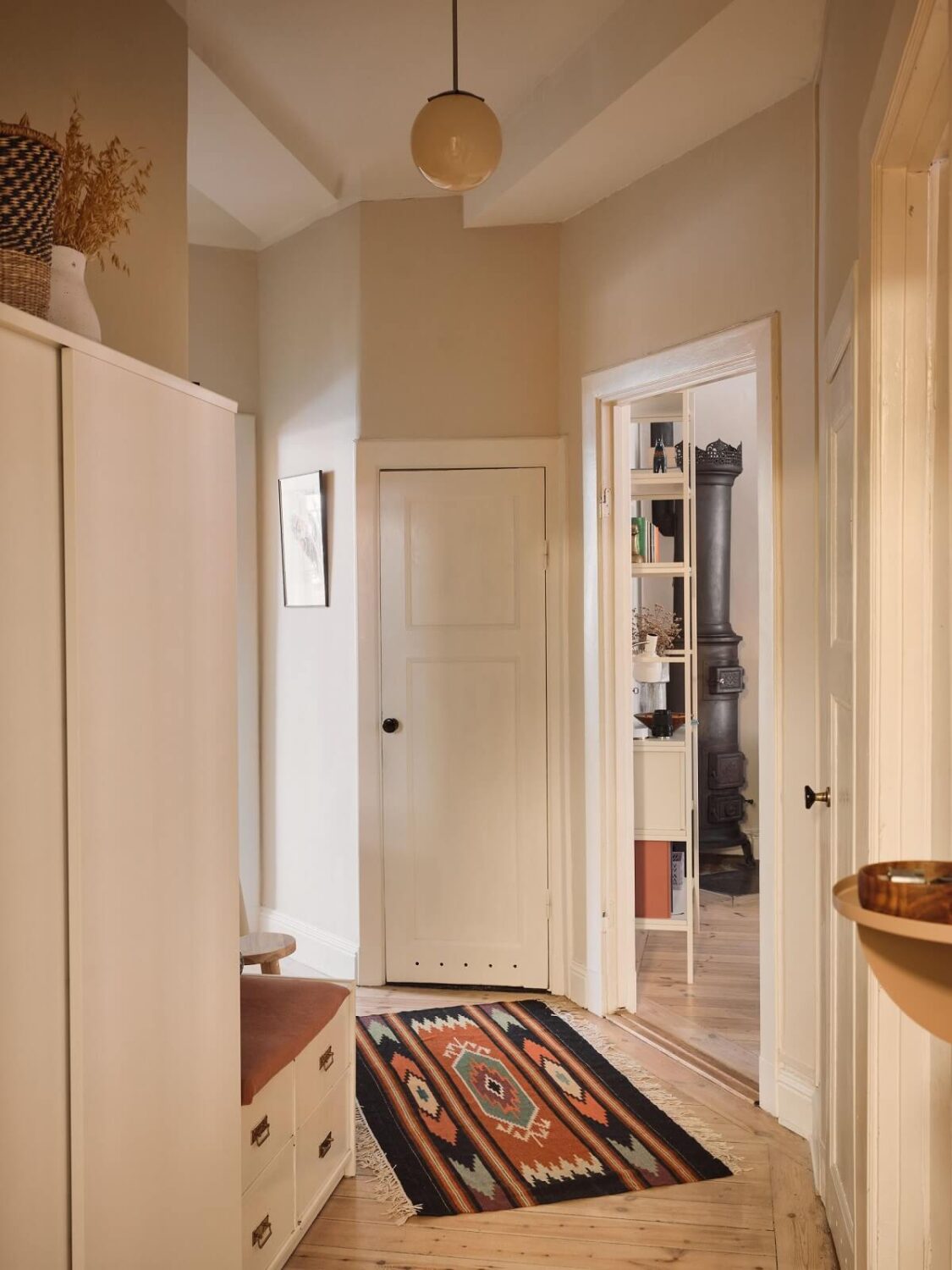 Serene Light Painted Spaces in a Swedish Apartment 18 hallway-with-bench