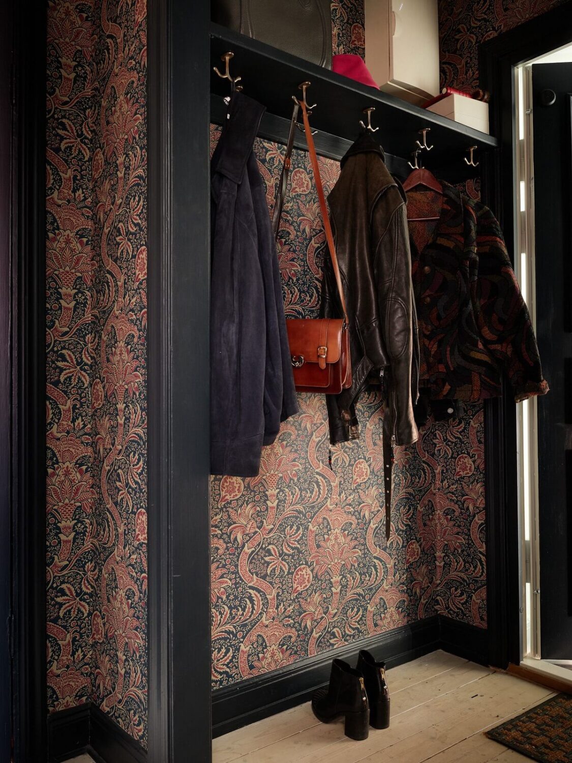 Cozy Vintage Style in a Swedish 1920s Apartment 16 hallway with coat storage and william morris wallpaper