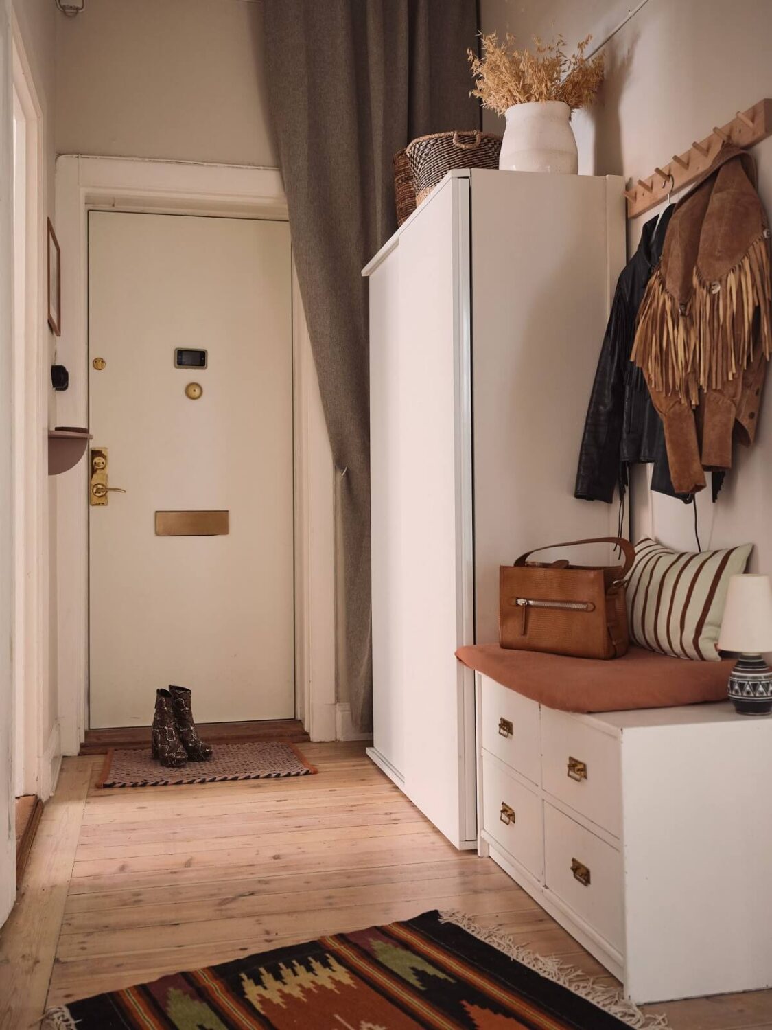 Serene Light Painted Spaces in a Swedish Apartment 20 hallway-with-storage-and-bench